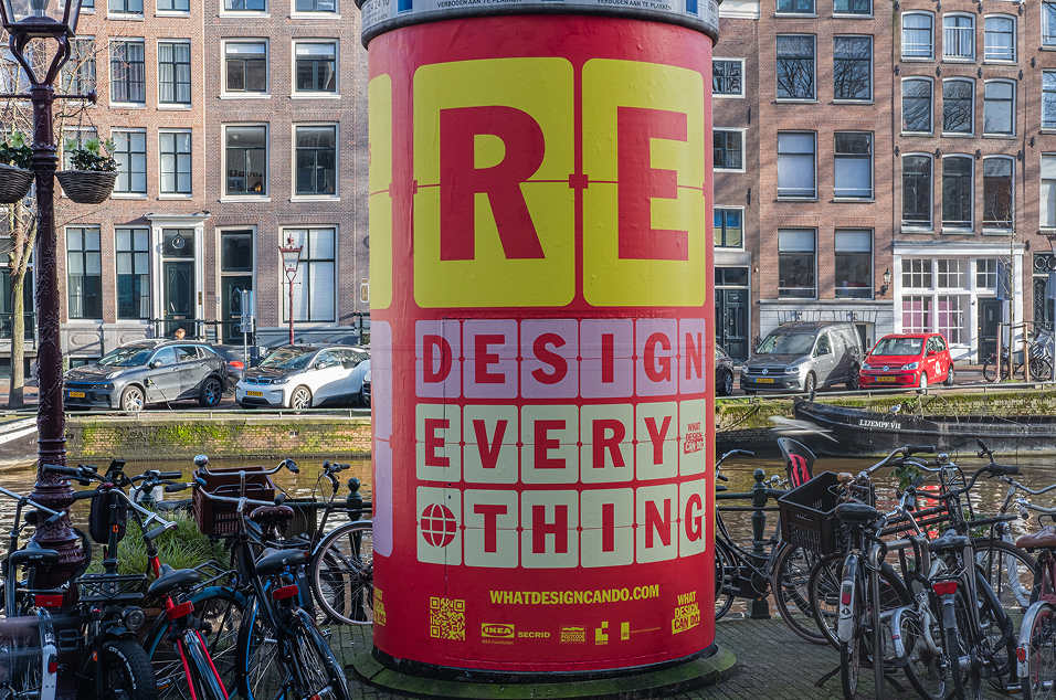 Redesign Everything poster wrapped around a street pillar.
